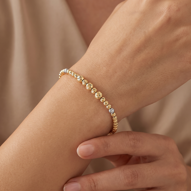Gouden dorika armband 14 karaat tricolor met geslepen bolletjes