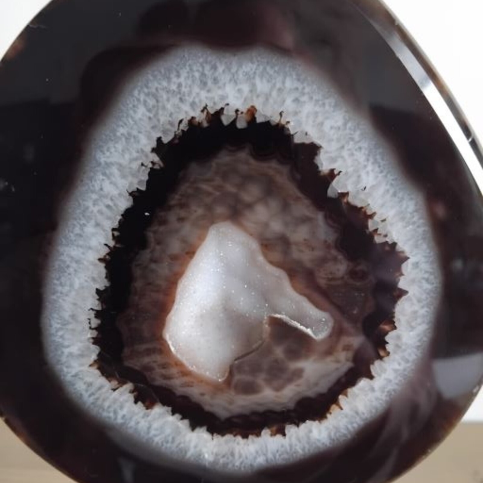 Agate with rock crystal geode on stand