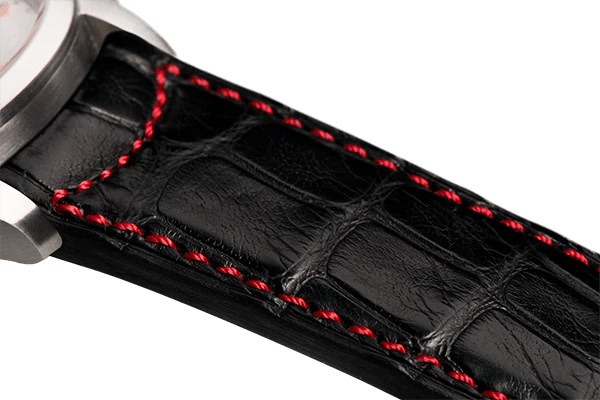 Bracelet plein en alligator noir surpiqué rouge