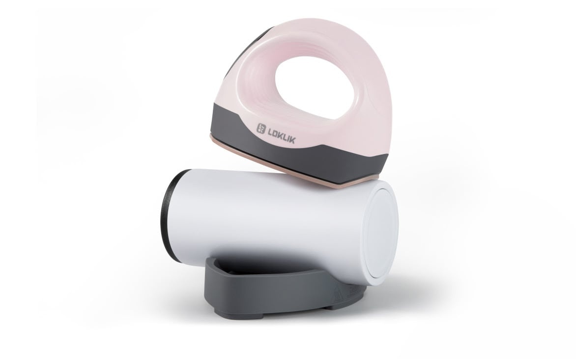 LOKLiK ImPress™ Mini 3 in Bubble Blue ironing with its curved heat plate on a tumbler sitting in the safety base.