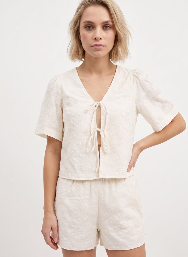Beige top met bloemen en strikjes