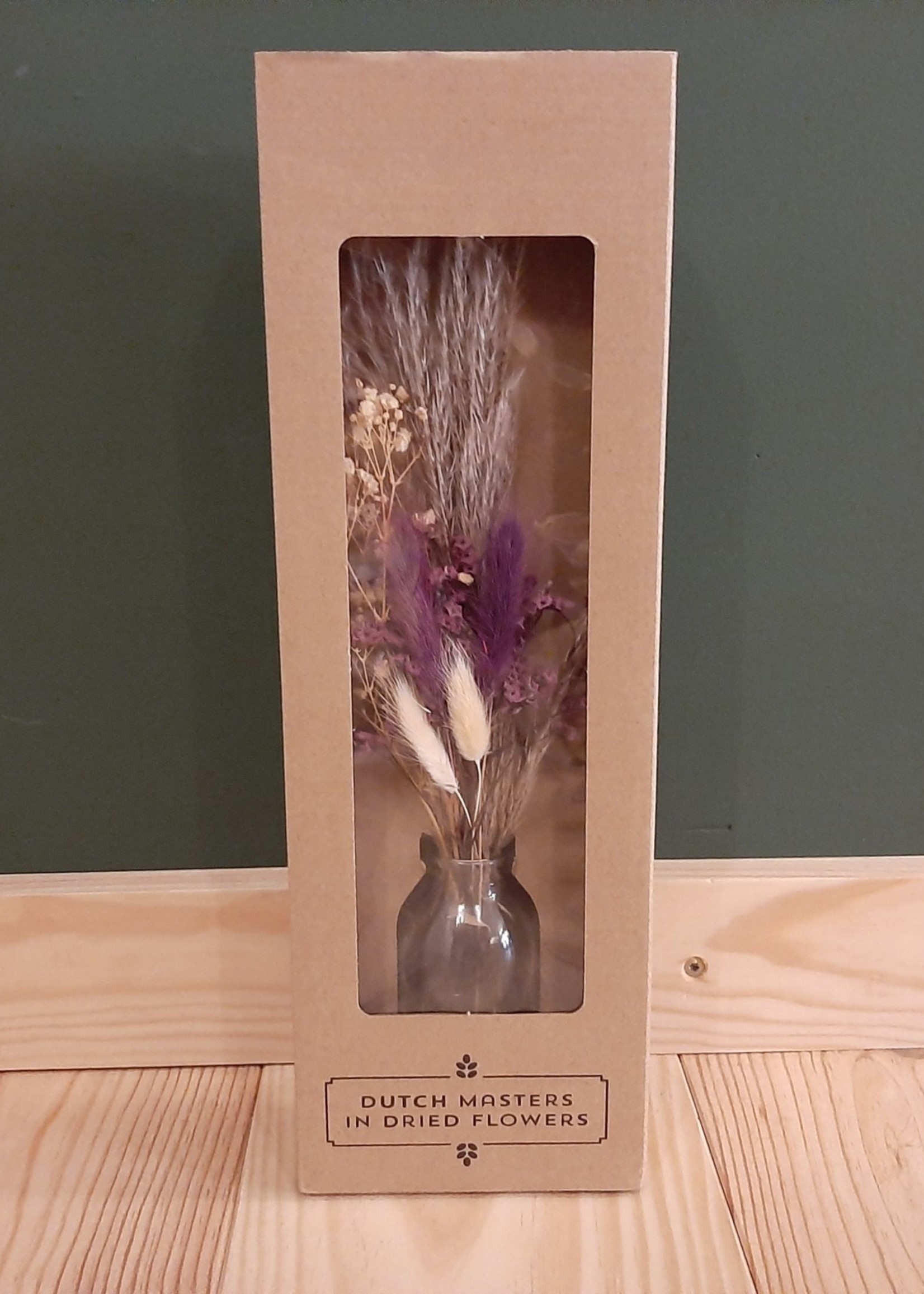 Bouquet of dried flowers in glass bottle