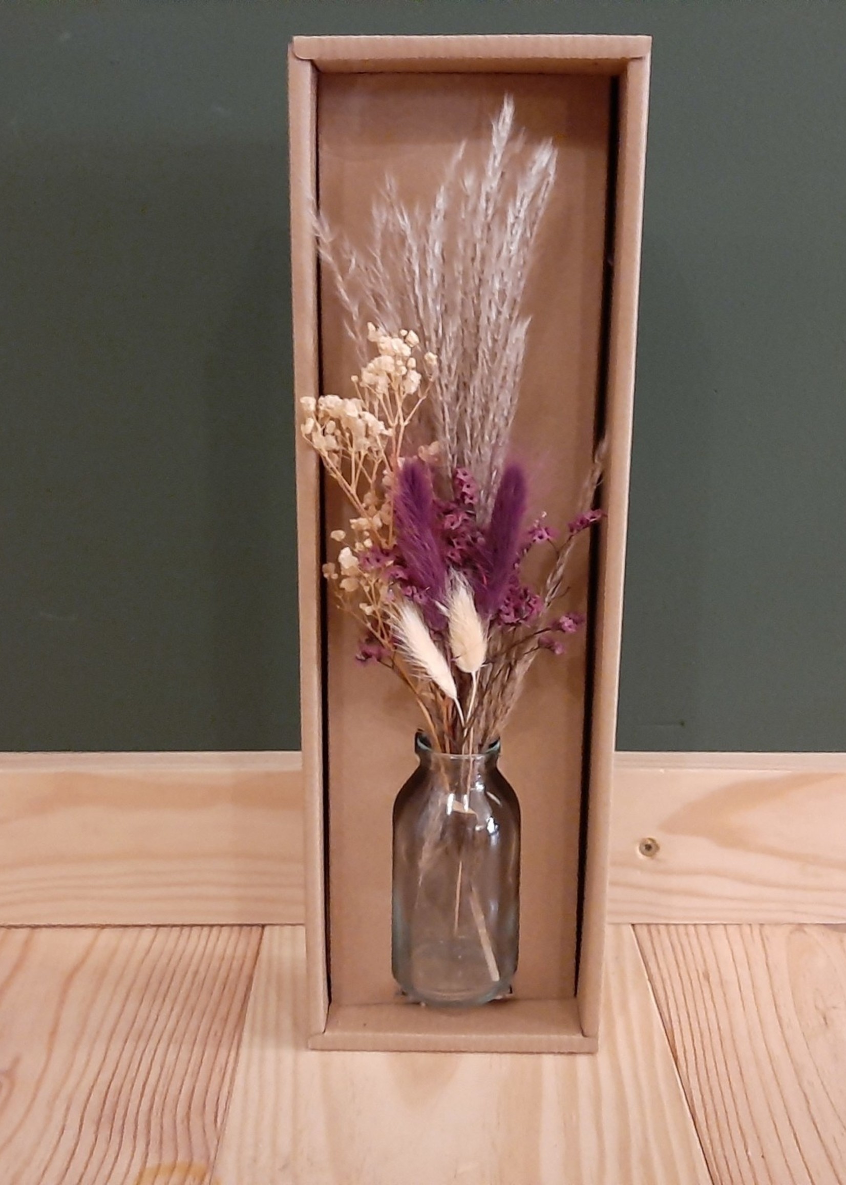 Bouquet of dried flowers in glass bottle