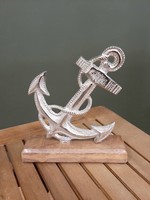 Silver colored nostalgic metal anchor with wooden base