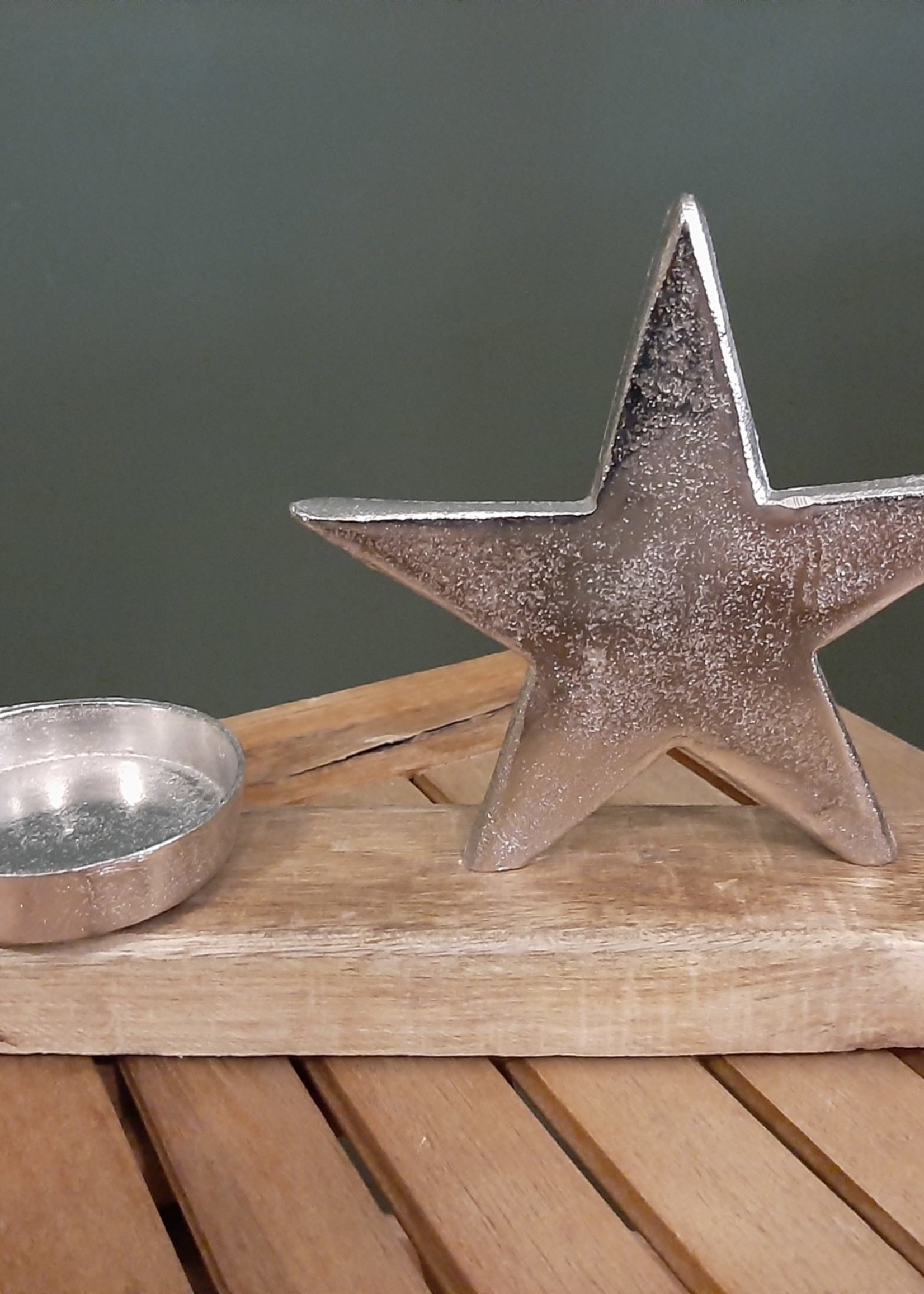 Metal candle holder with star and wooden base