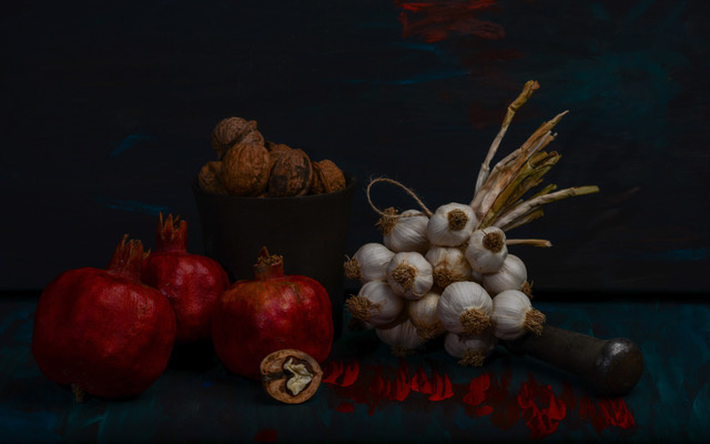 Still life with garlic, walnuts and pomegranates