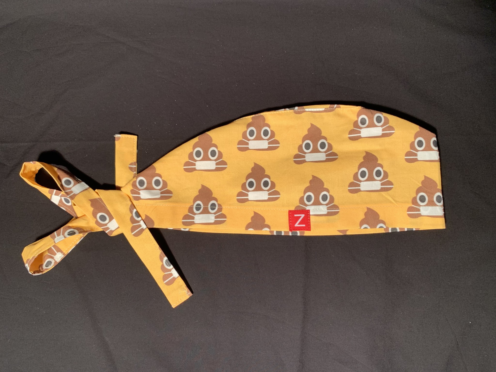 Smiling poo with mouth mask