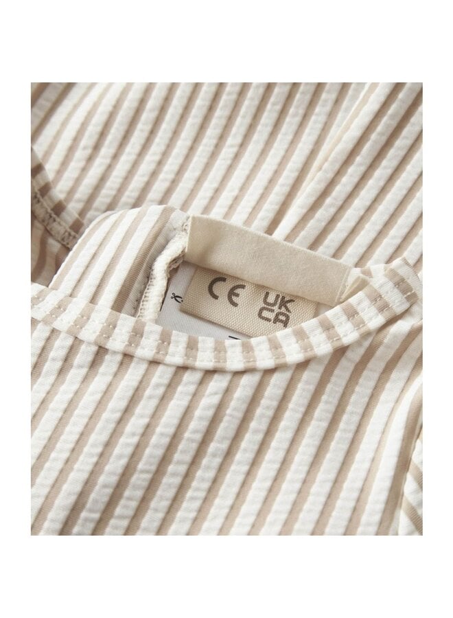 NBNFONDO ls uv suit lil SS26