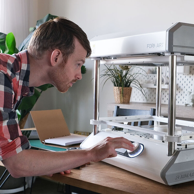 A man using a MY YARD desktop vacuum former