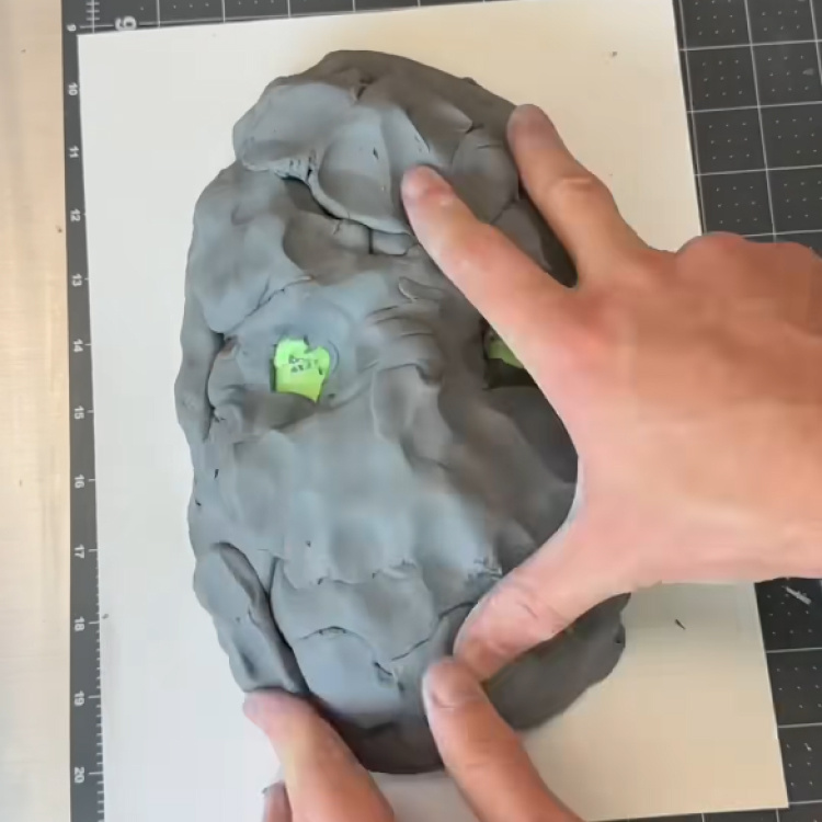 Nick makes the mould for the mask out of clay