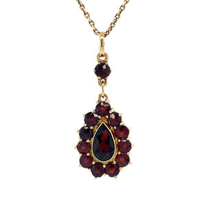 Gold entourage pendant with garnet 14 krt