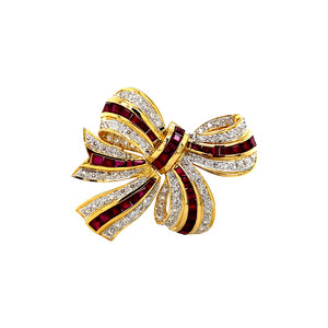Gold bow brooch with ruby and diamonds 18 krt