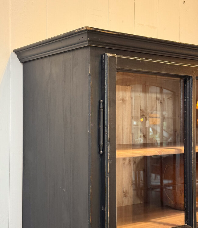 Black vintage wooden display cabinet with old glass