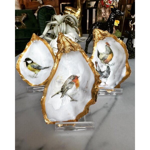 Hand-decorated golden oyster with robin