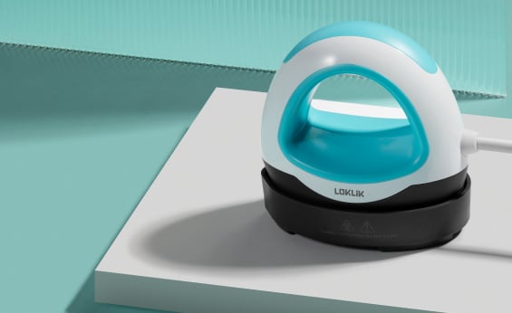 Front view of the LOKLIK Mini Heat Press LOKLIK Blue on a white table in front of a teal background.