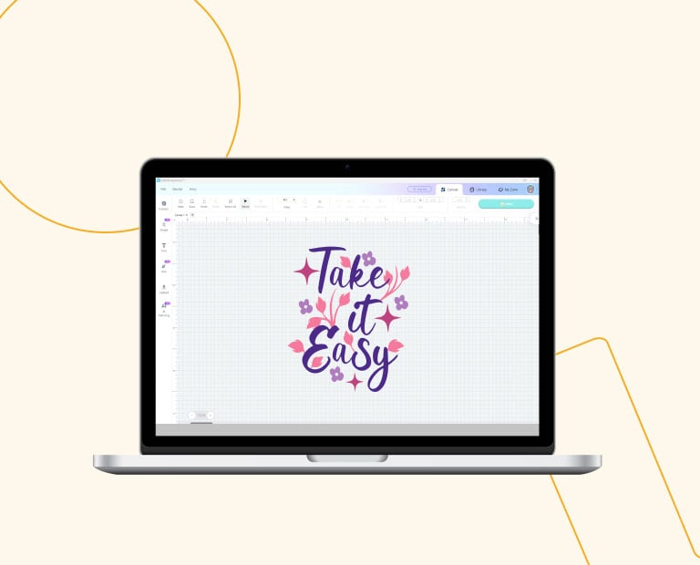 An laptop with LOLiK IdeaStudio open. It shows a design with the text 'Take it Easy' in dark purple with lilac flowers and pink stars scattered around it.