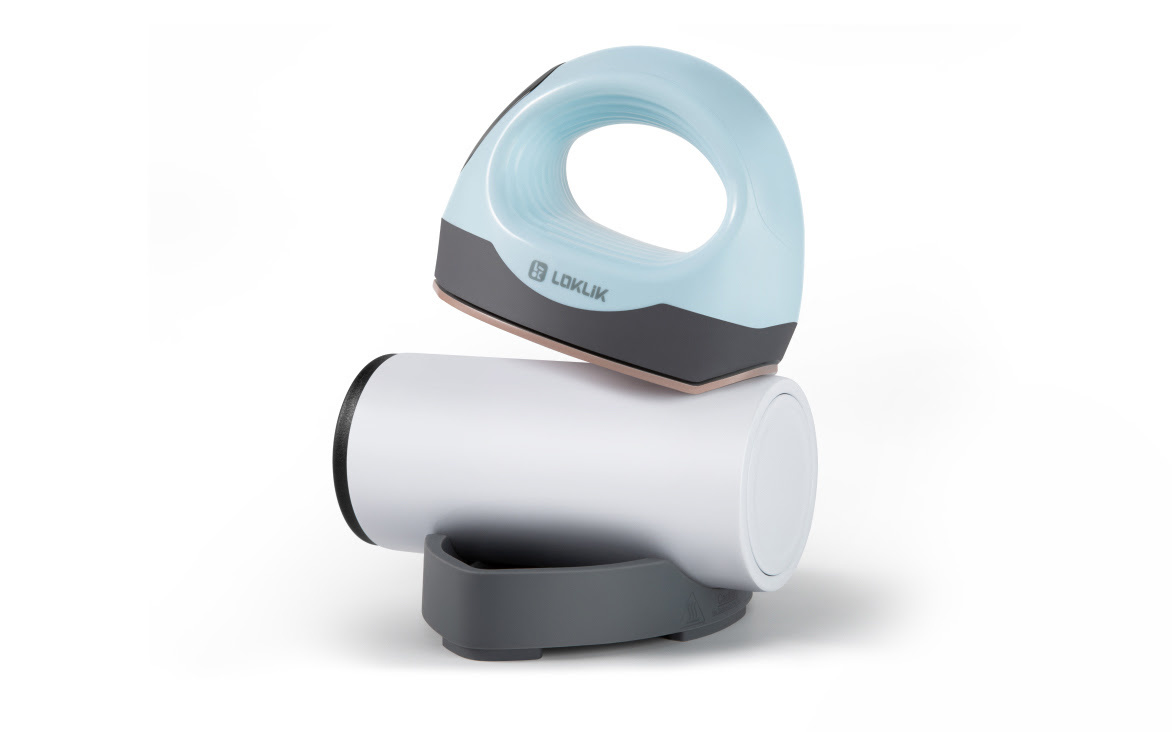 LOKLiK ImPress™ Mini 3 in Bubble Blue ironing with its curved heat plate on a tumbler sitting in the safety base.