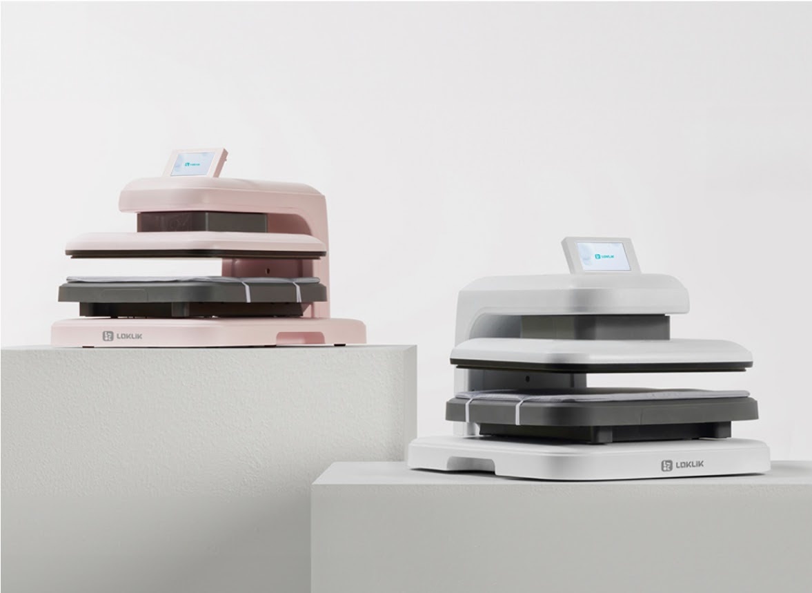 A LOKLiK ImPress™ Auto 2-Smart in Pastel Pink and Daisy White on two white pedestals against a white background.