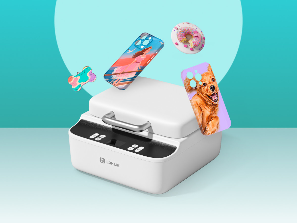A closed LOKLiK Phone Case Heat Press with floating items above it. The examples are from left to right: a dog bone to hang on a dog collar with a multicolor splashes print, a phone case with a drawing style print of a girl standing on the edge of a boat, a button with a pink doughnut with a bite out on it and a phone case with a picture of a smiling dog on it.