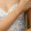Goudvergulde twist schakelarmband met zirkonia steentjes 18,5 cm