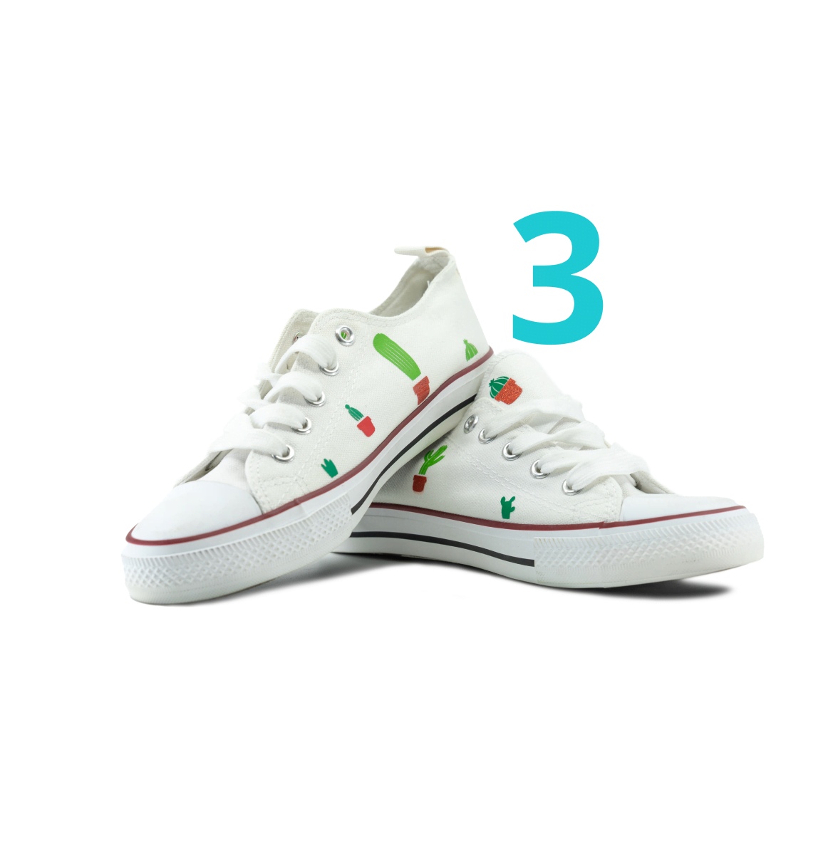 Two white canvas Converse shoes. There is a pattern of small cactusses in heat transfer vinyl ironed on them.