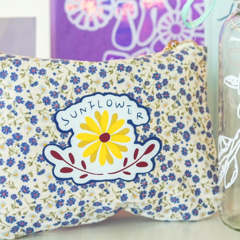 Little pouch in floral print with a heat transfer design of a sunflower.