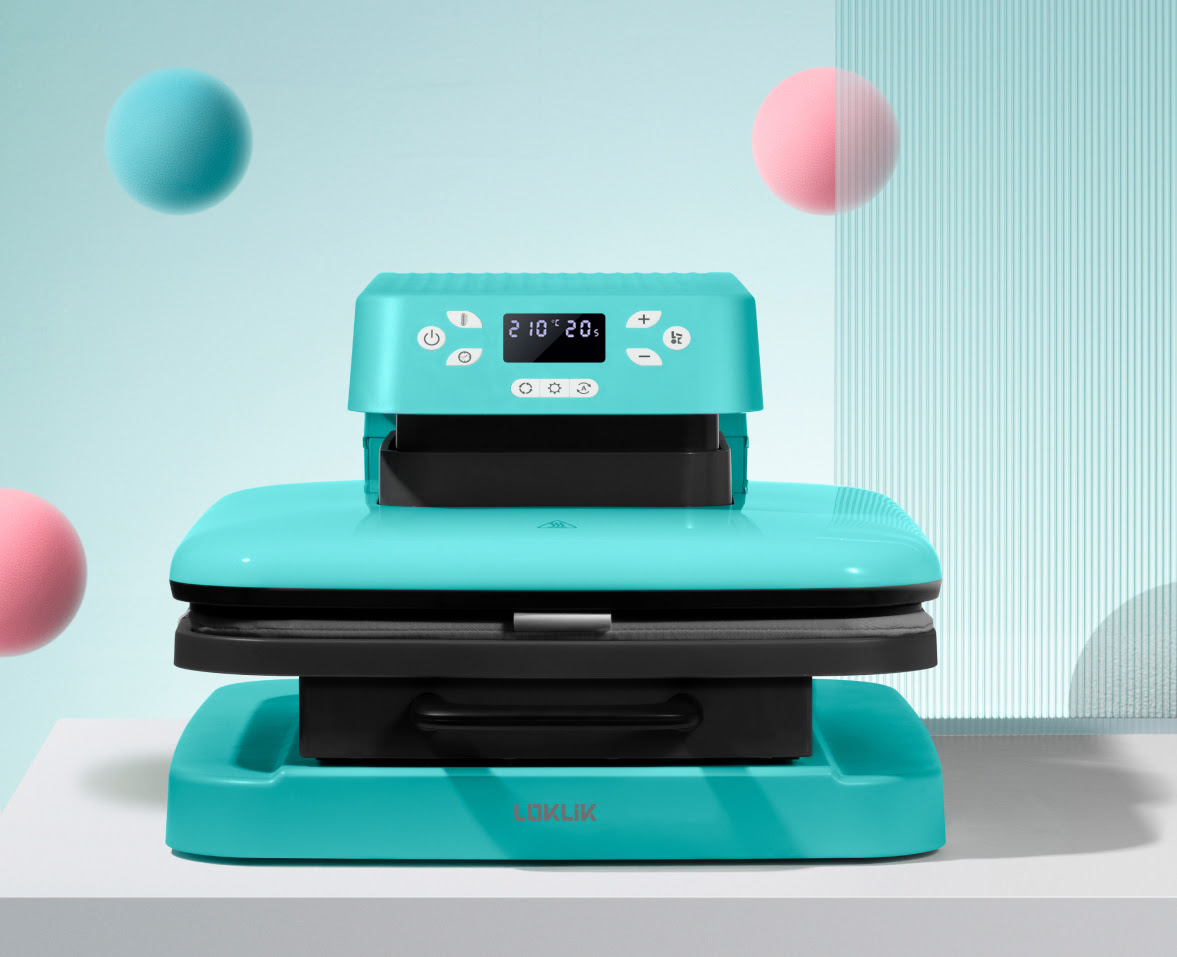 Auto Heat Press in LOKLiK Blue on a grey table in front of a light blue background. There are 3 floating spheres. Two in pink and one in aqua blue.