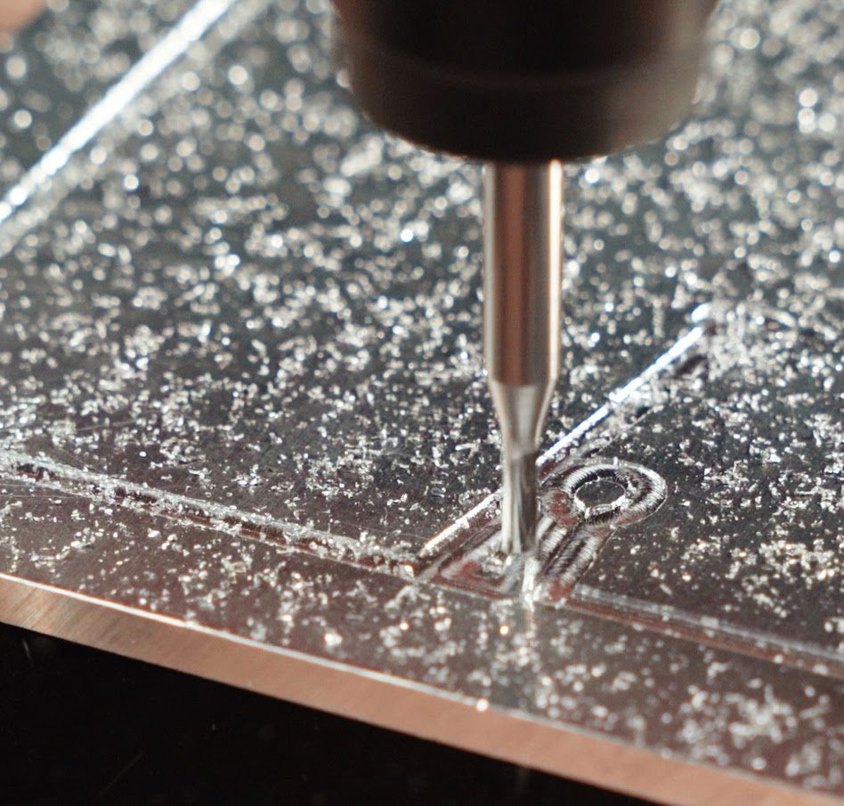 Close-up of the bit of a CNC router milling metal.
