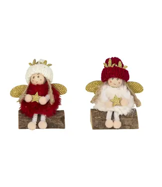 Stoffen engel zittend op houten stam Stoffen engel zittend op houten stam