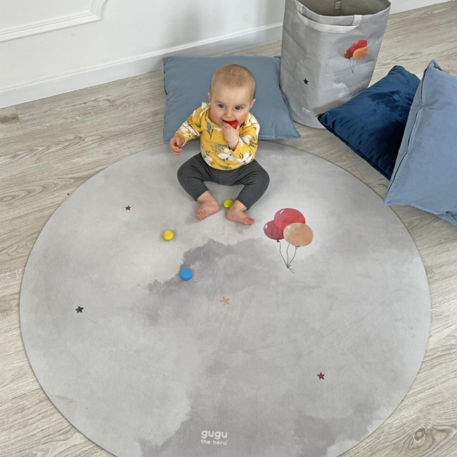 Round play mat with hot air balloon design in soft colors, durable and comfortable