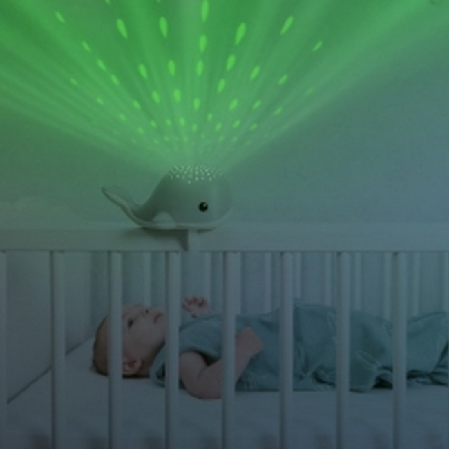 Soothing whale-shaped projector for children in soft pink tone