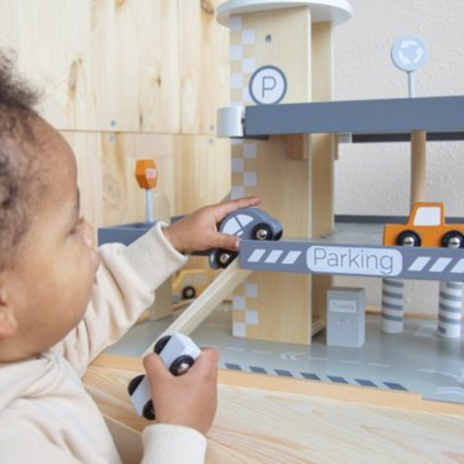 Wooden parking garage with multiple levels and play features