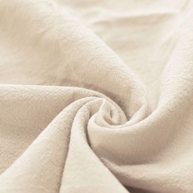 Babynest mit Schleife aus hellbeigem, gewaschenem Baumwollstoff – weich, sicher und kuschelig