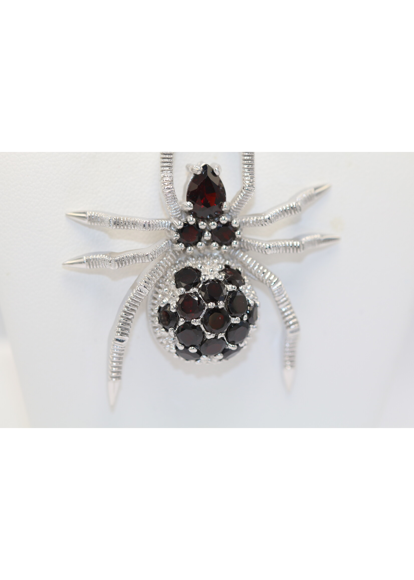 925 rhodium plated silver pendant set with natural garnets