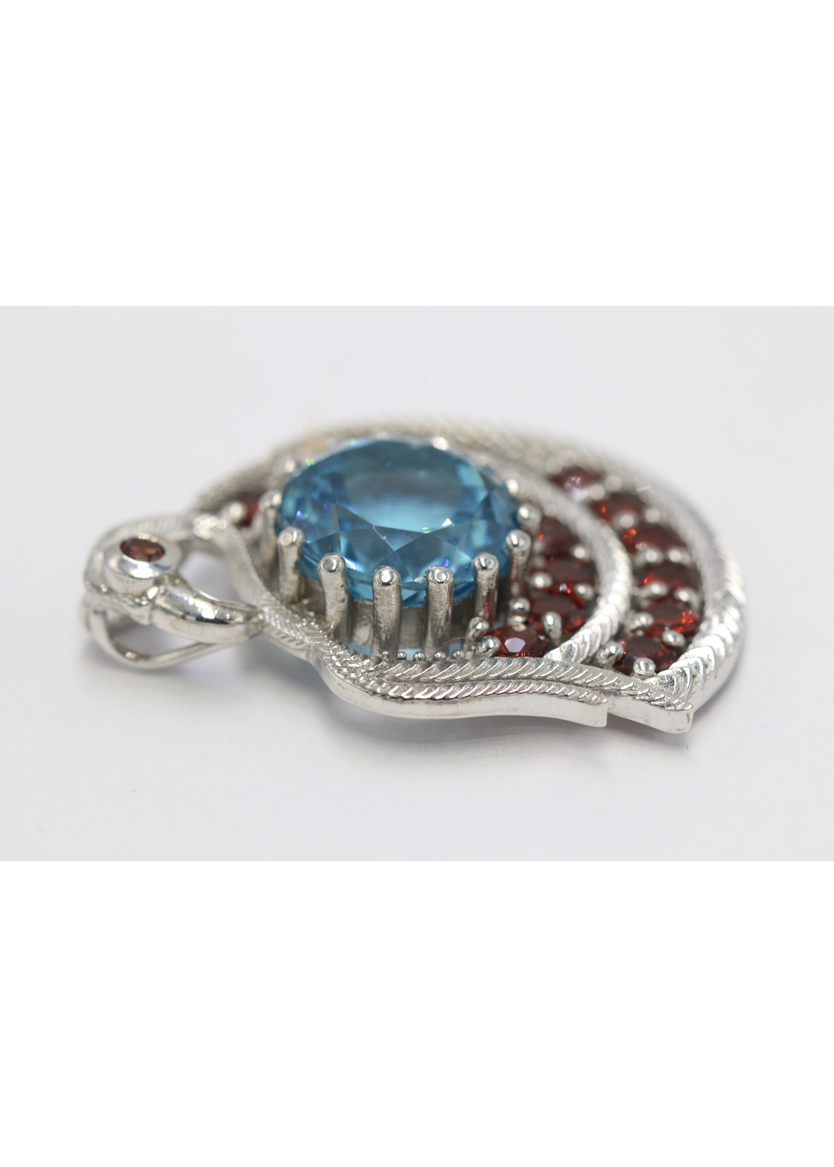 925 rhodium plated silver pendant set with natural topaz and garnets