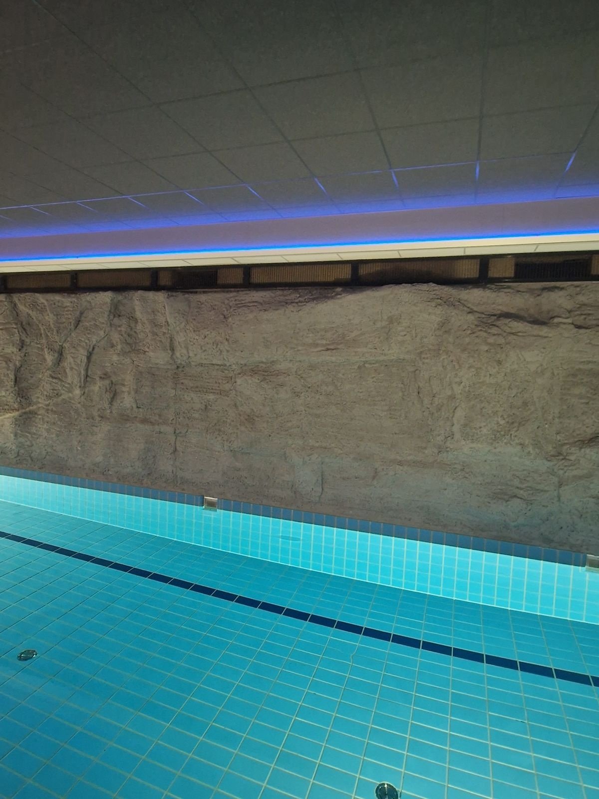 Schwimmbadbereich mit LED-Lichtlinien - Zwembad met blauwe LED lichtlijnen en betegelde vloer. voor Zwembad ruimte voorzien v