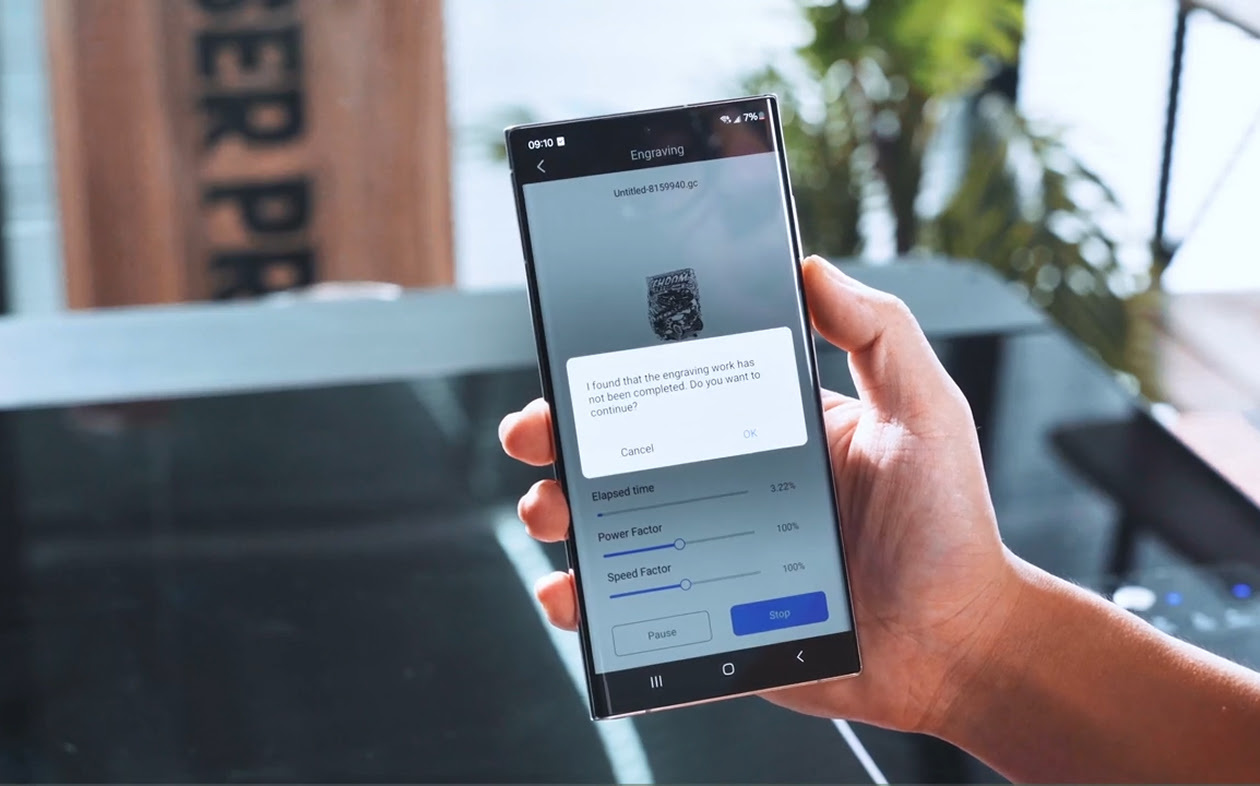 Hand holding a smartphone with a message asking if they want to continue after the power was cut.