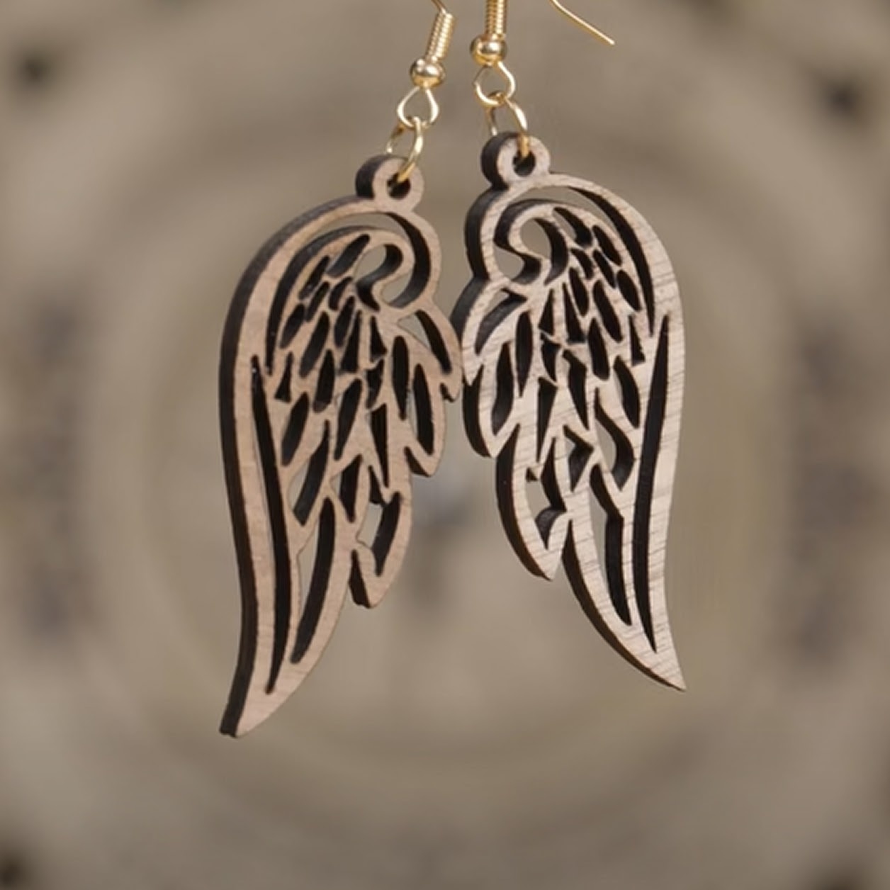 Wooden lasercut earrings of the wings of an angel.