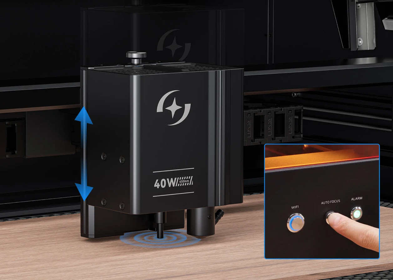 Close-up of the 40 W diode module and the autofocus system. Inset of a finger pressing the autofocus button on the front of the machine.
