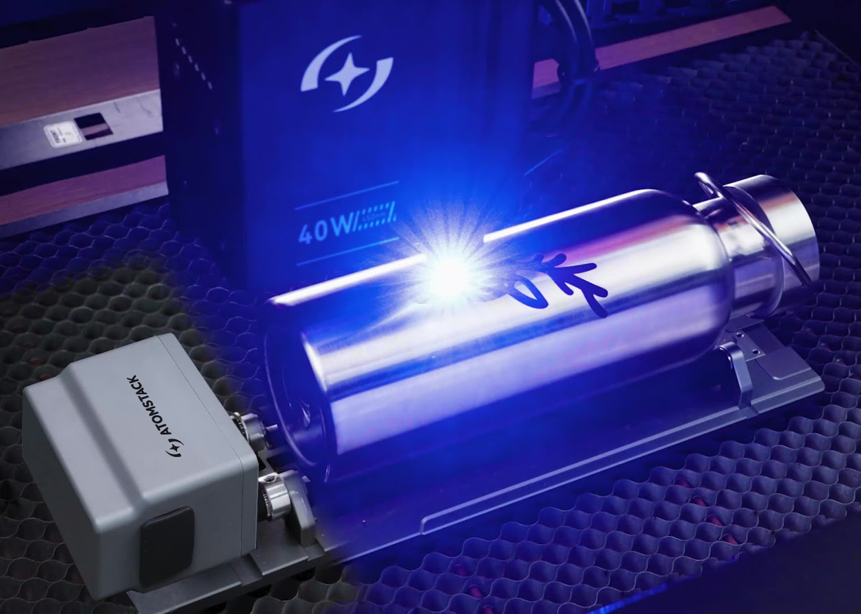 Close-up of the R6 Rotary Roller with a metal water bottle placed on it while it is being engraved.