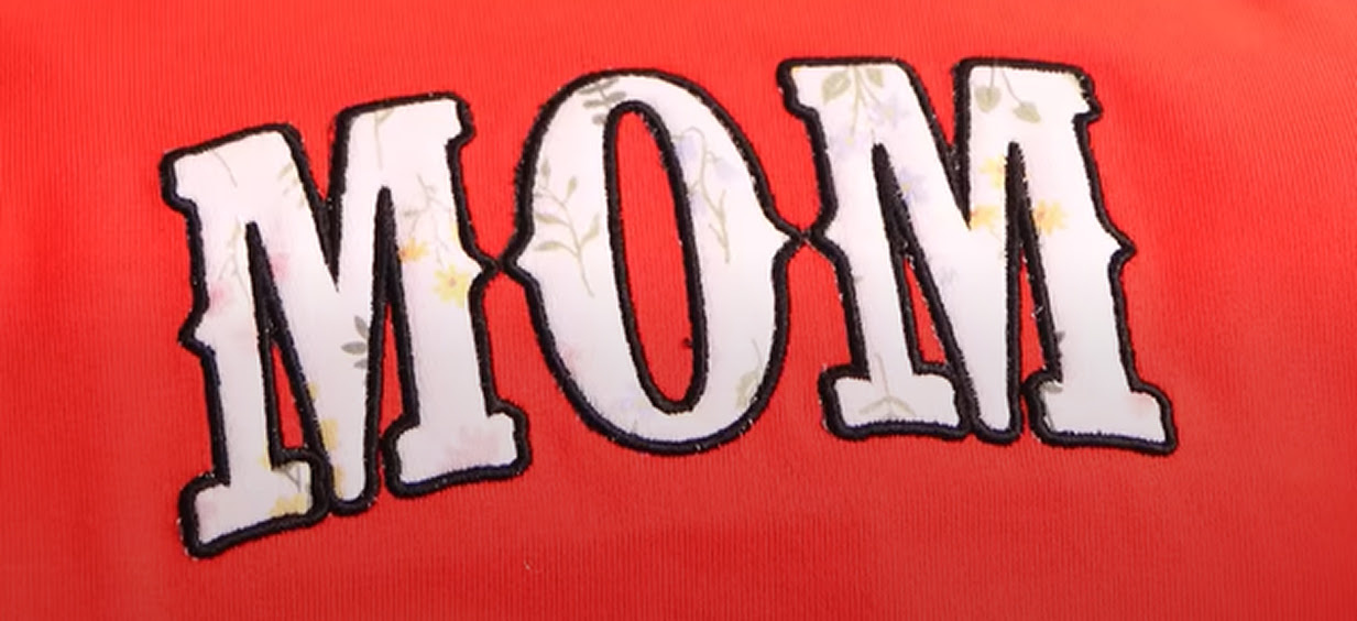 Appliqué design of the word MOM.