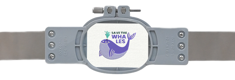 Small embroidery hoop with an embroidered design of a while and the text: Save the whales.