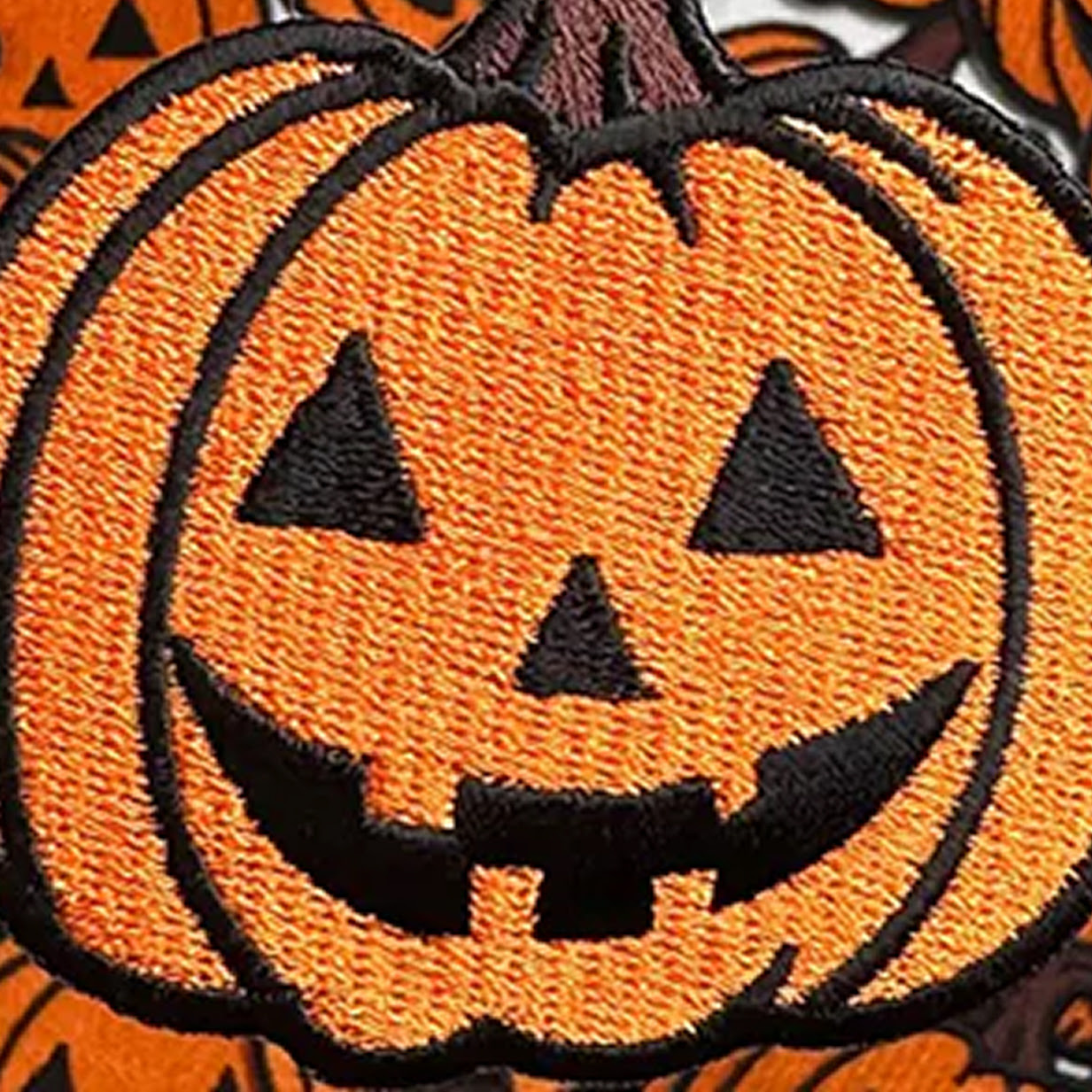 Close-up of an embroidered patch of a pumpkin.