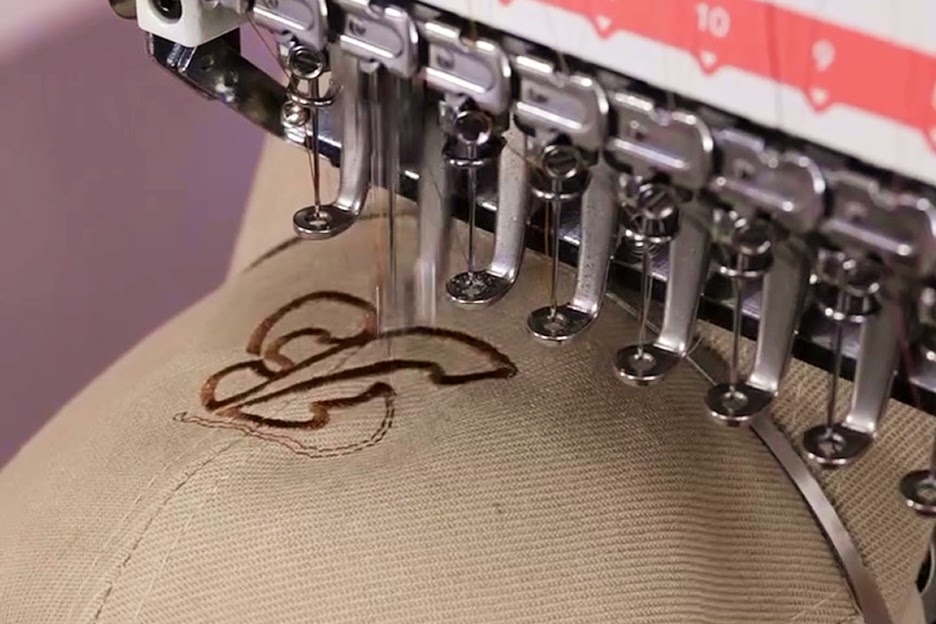 Close-up of the PooLin EOV embroidering lettering on a beige cap.
