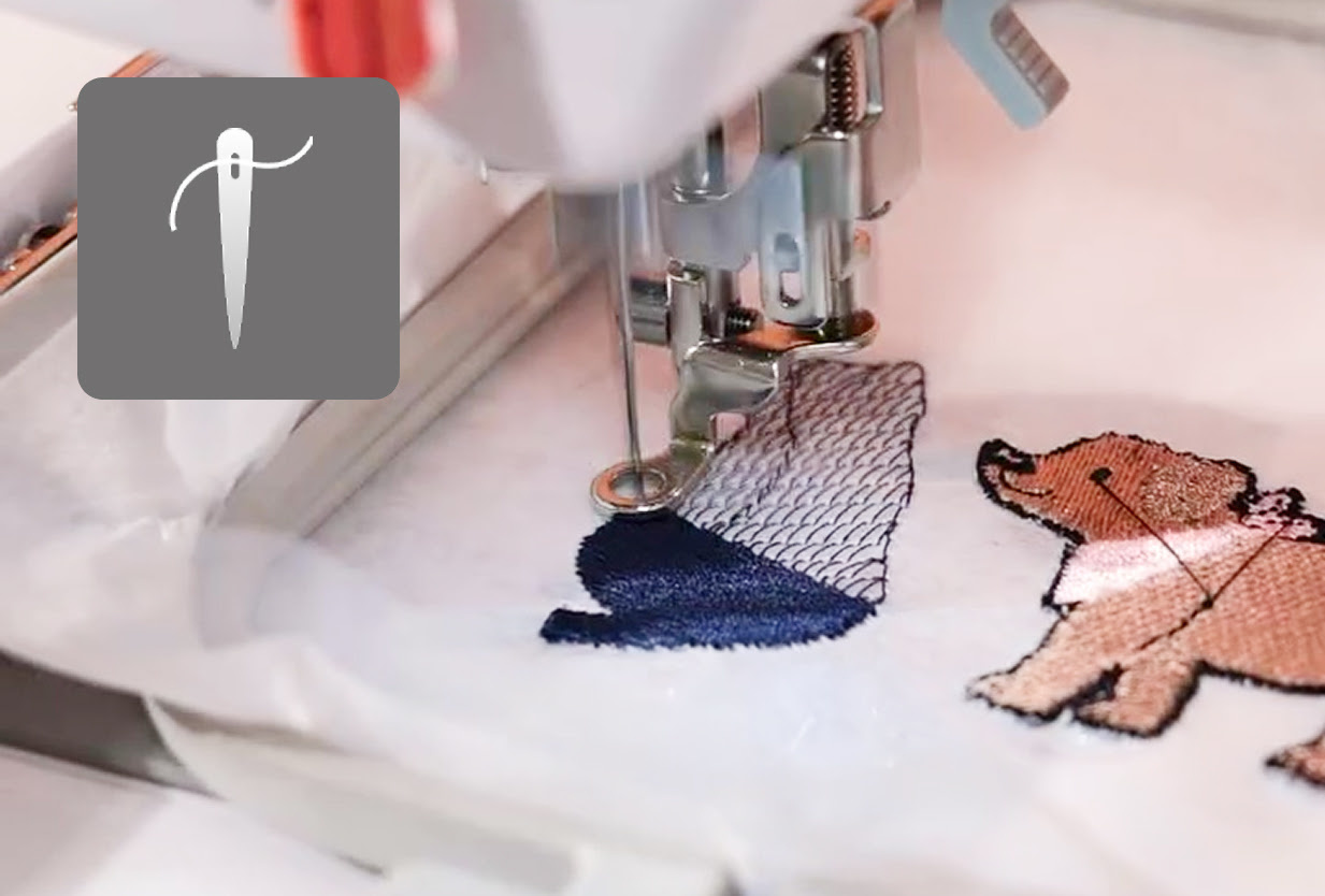 A PooLin EOC03 embroidery machine on a table with a hoop attached. The screen is on.