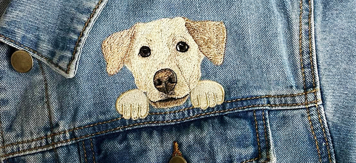 Embroidered dog on a jeans vest.