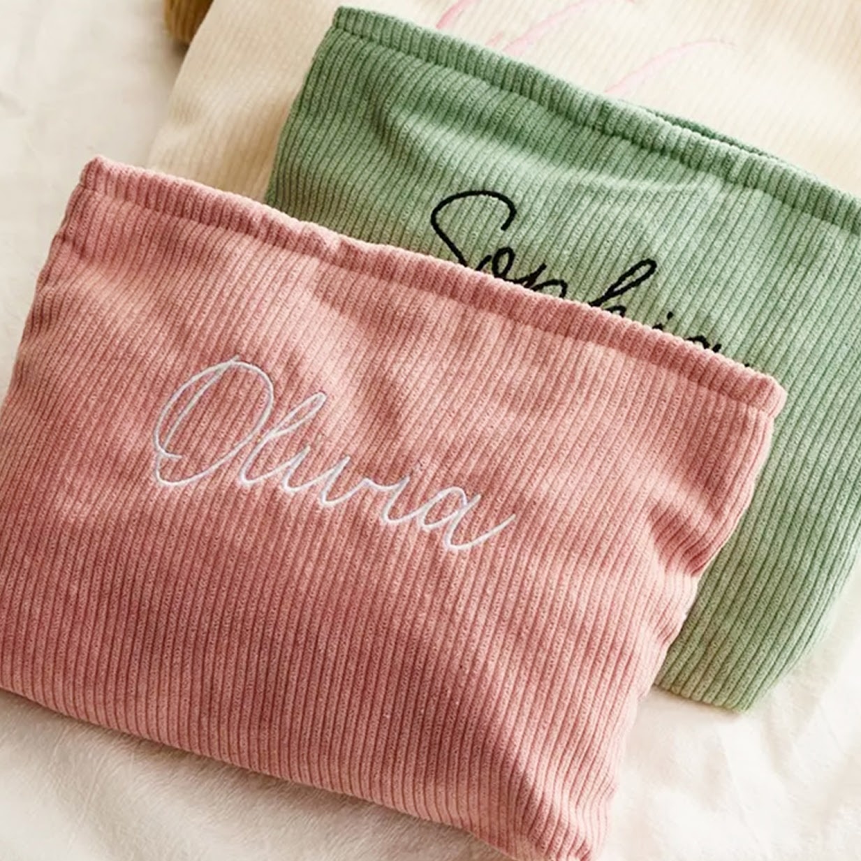 Two pouches with embroidered names.