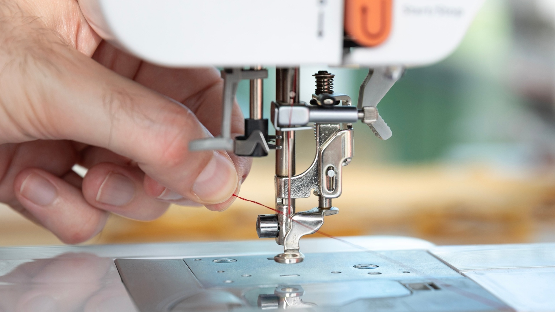 Pull the thread through the eye of the needle