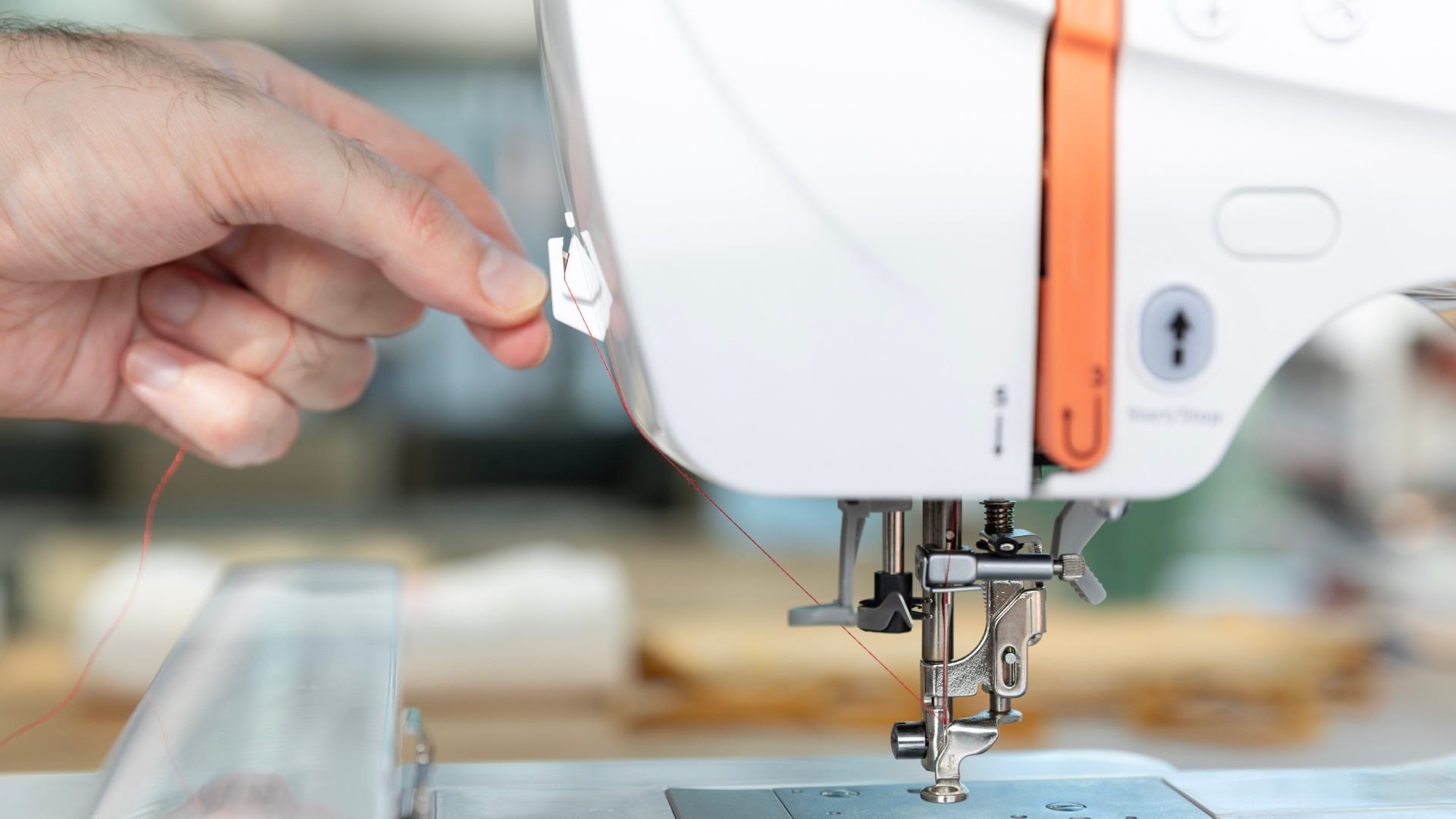 Trim any excess thread with the cutter on the left side of the embroidery machine