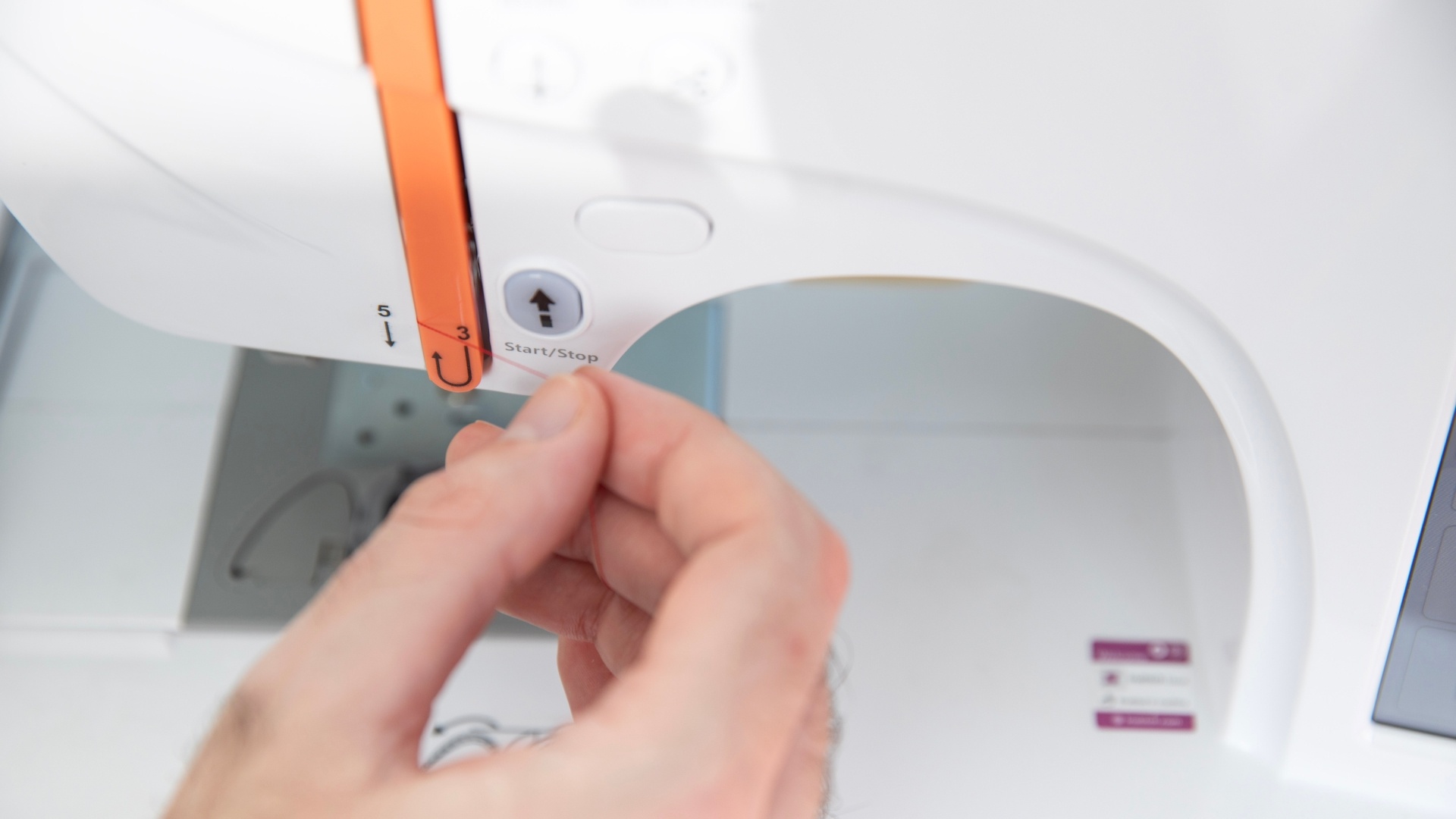 Step 3: pull the thread back up on the left side of the guide
